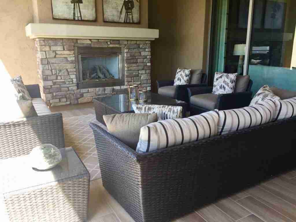 outdoor furniture and a fireplace on a patio WZT6PMN